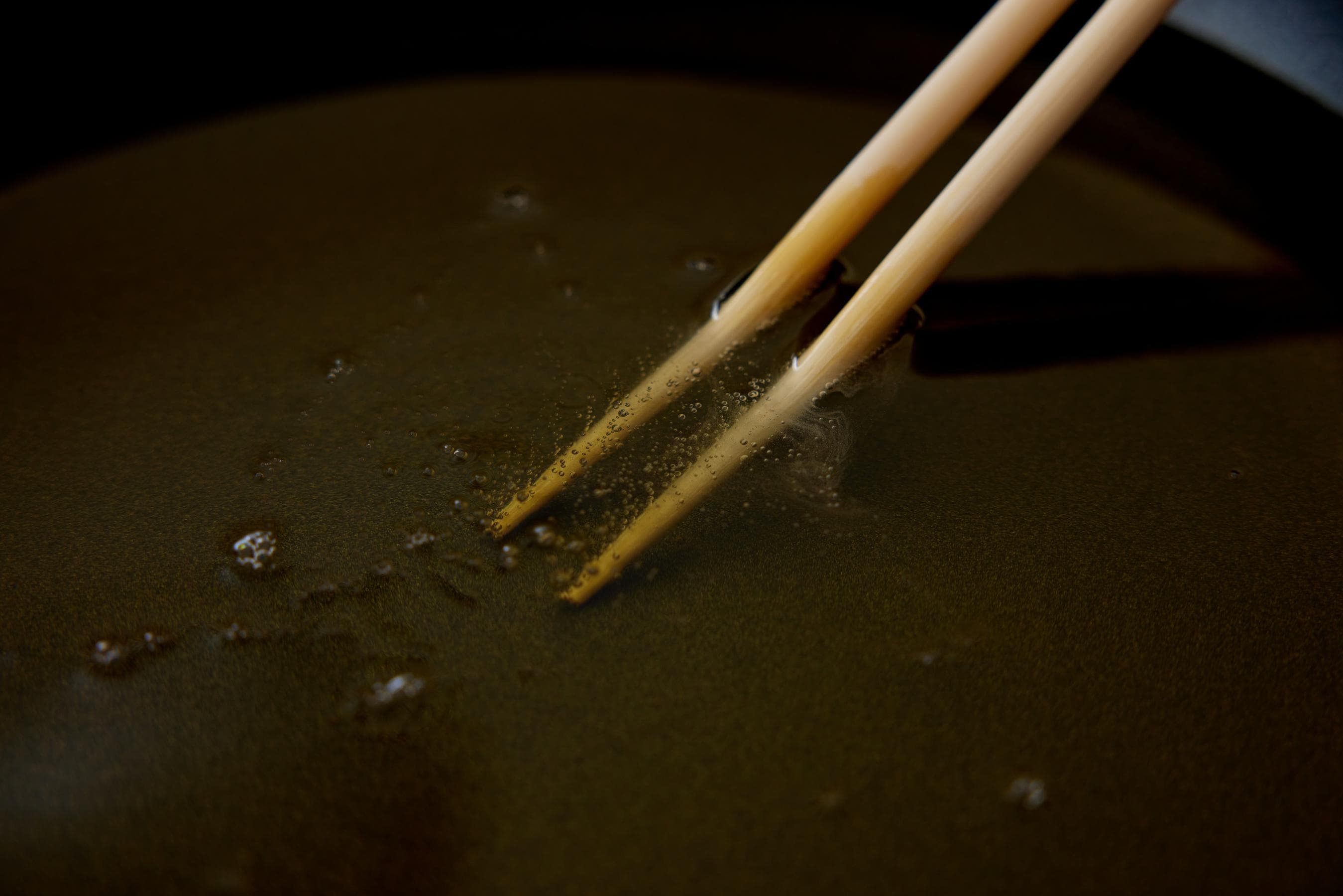 bubbles rising from the tips of the chopsticks