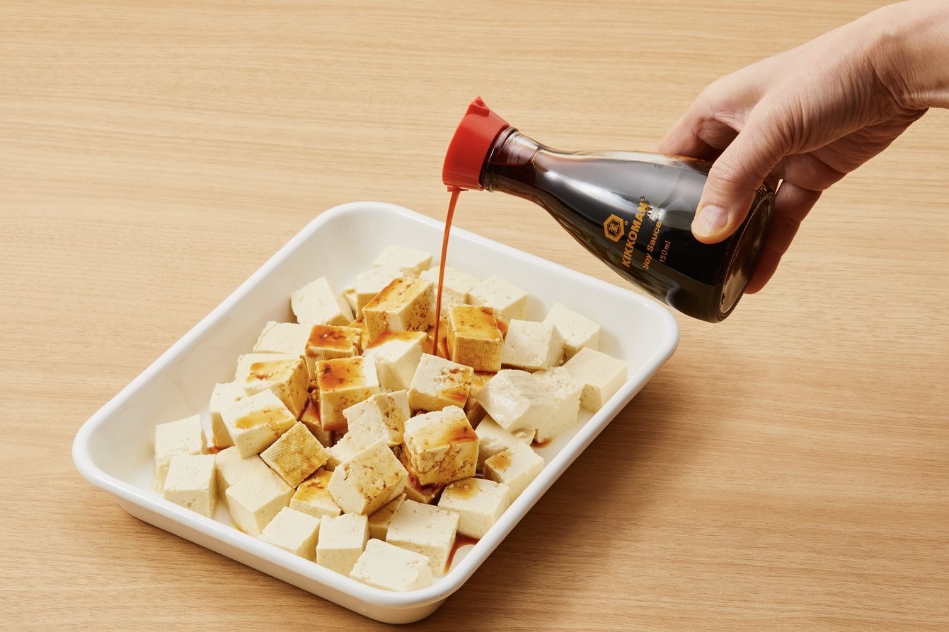 Season the tofu with soy sauce