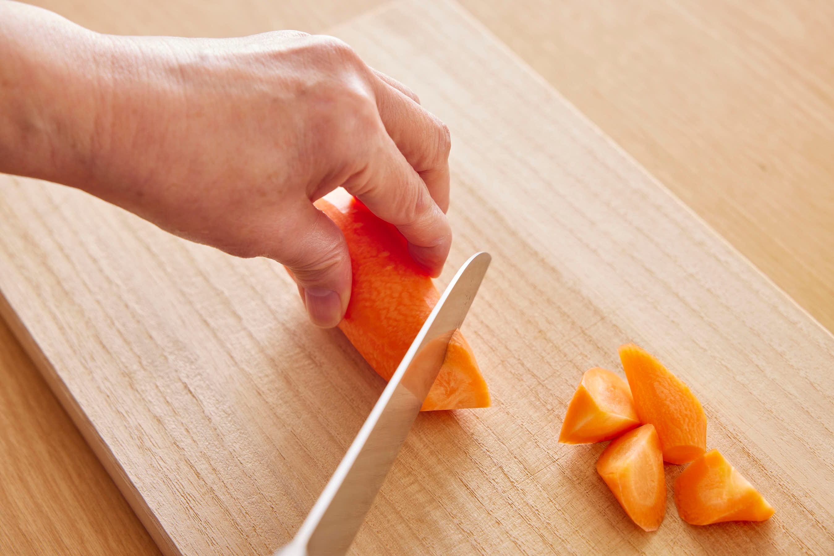 Cutting carrots into bite-sized chunks