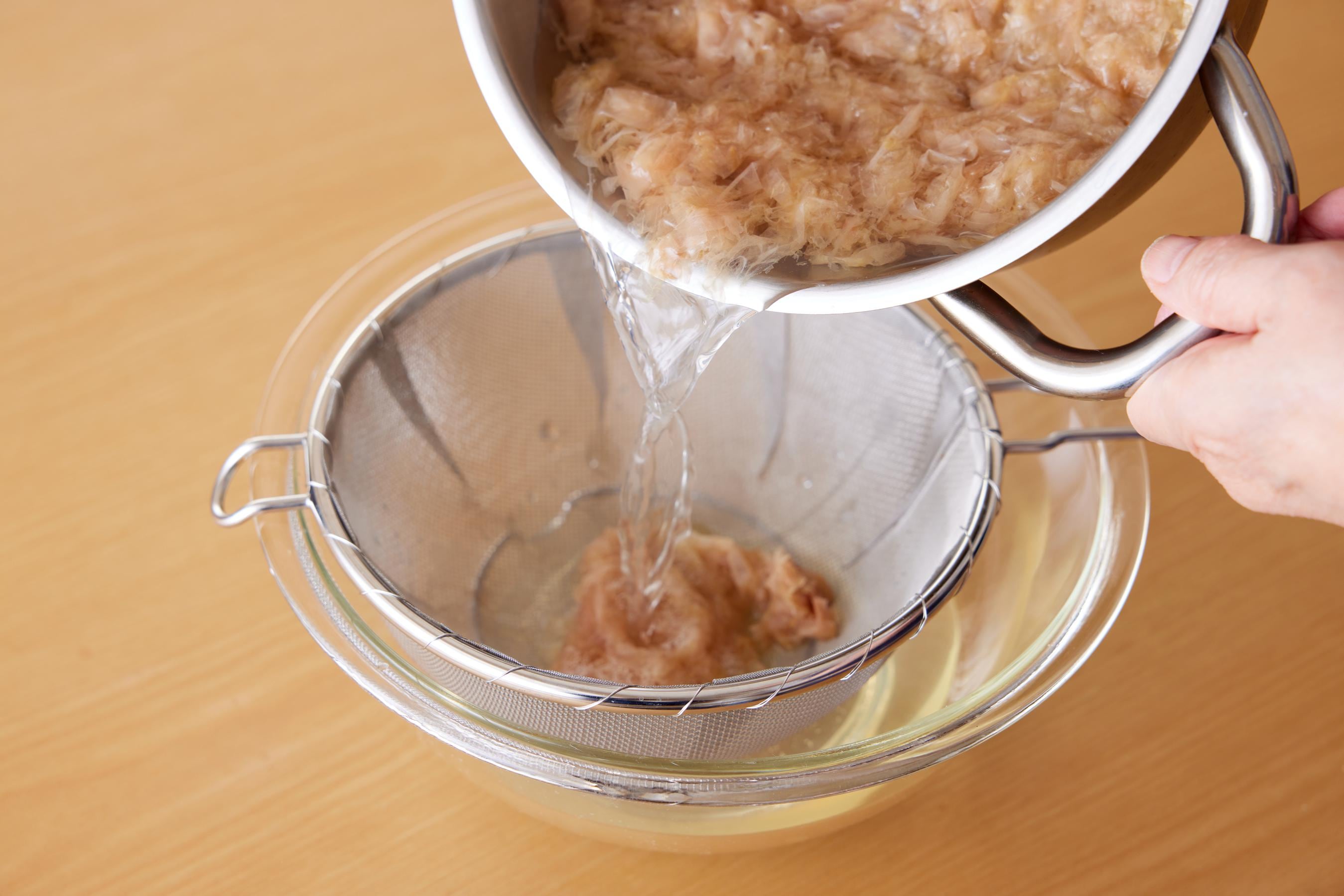 straining bonito flakes to extract the broth