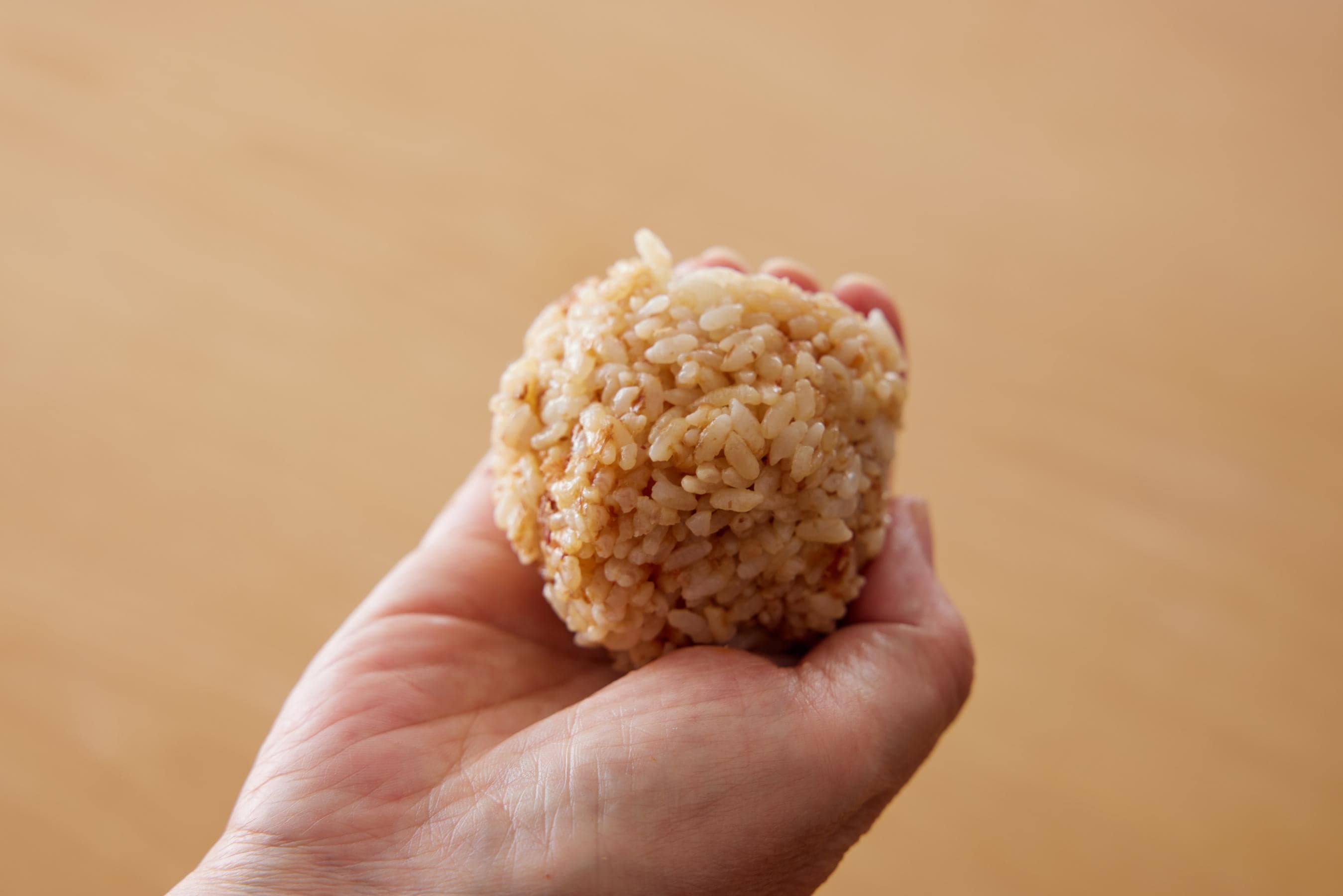 rolling the bonito soy sauce rice into a ball
