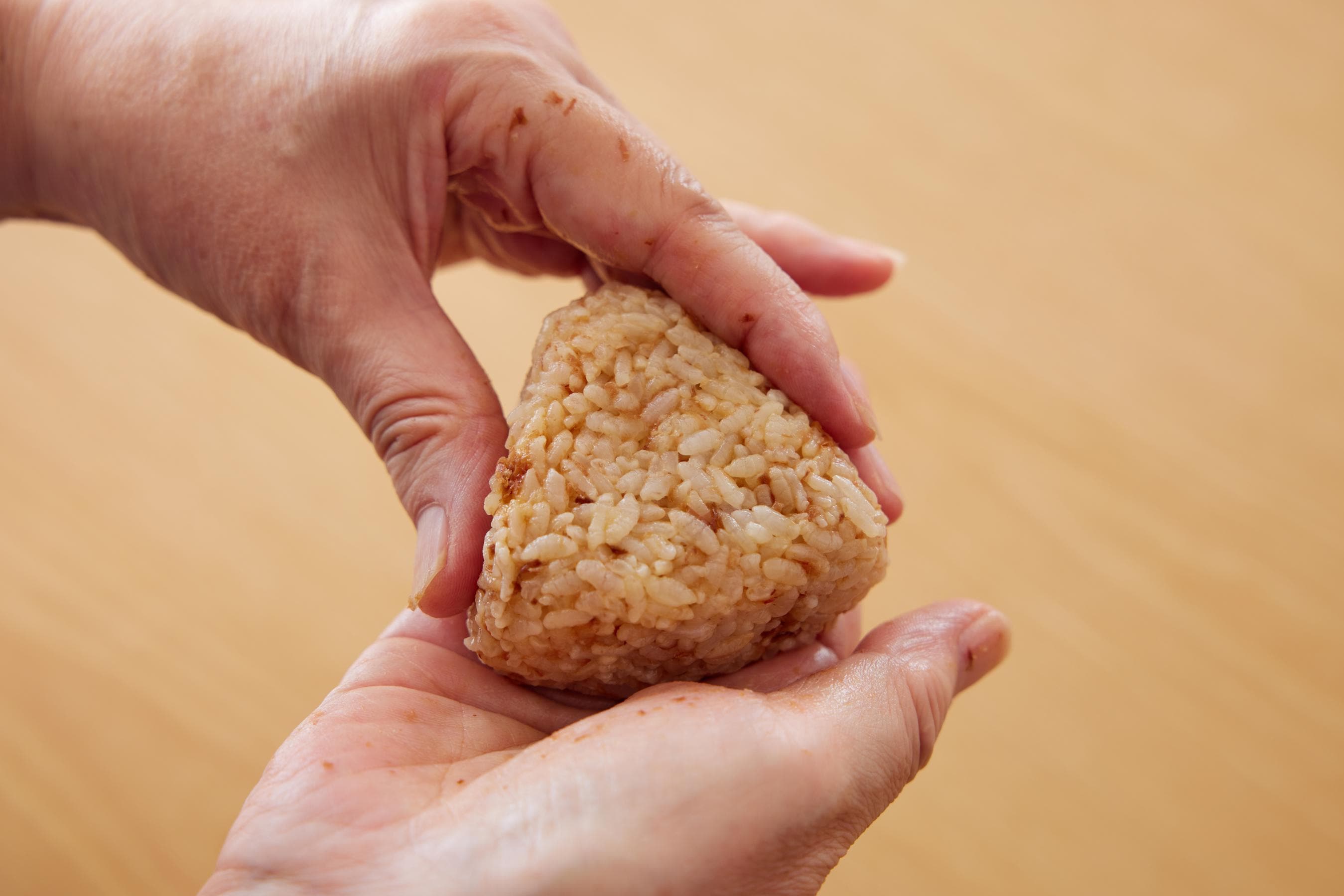 shaping the rice ball into a triangular shape