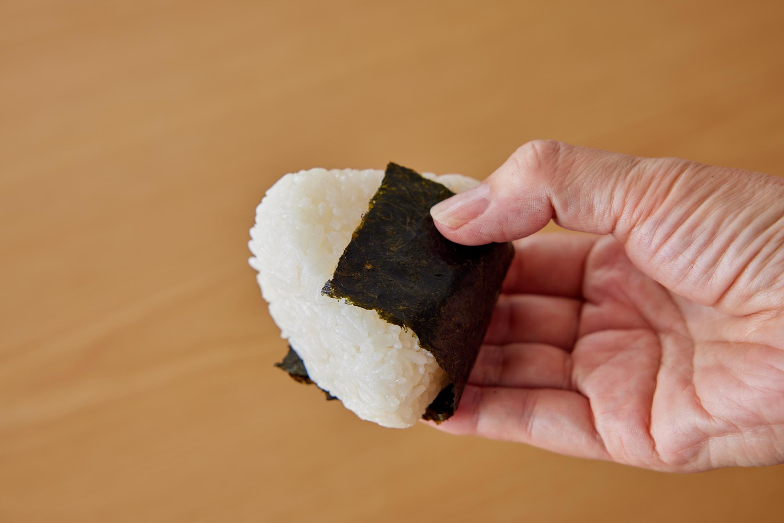 holding Onigiri with a hand