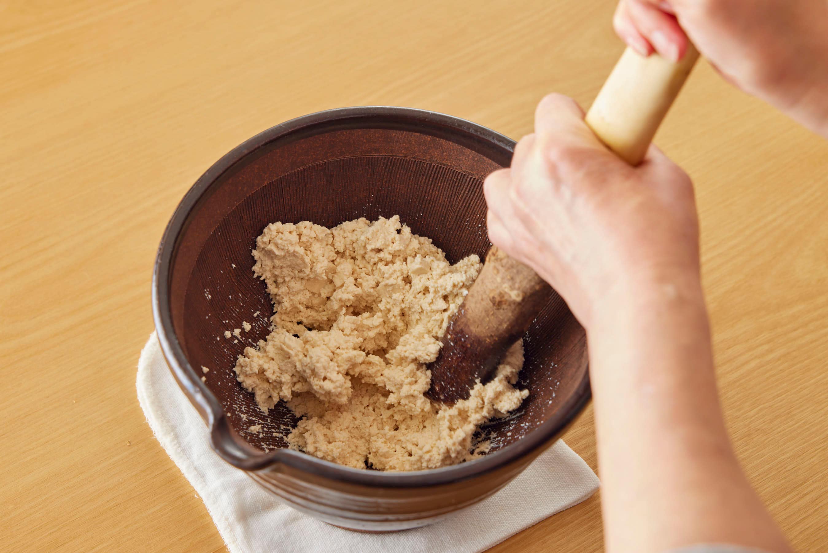 Mashing tofu in a mortar