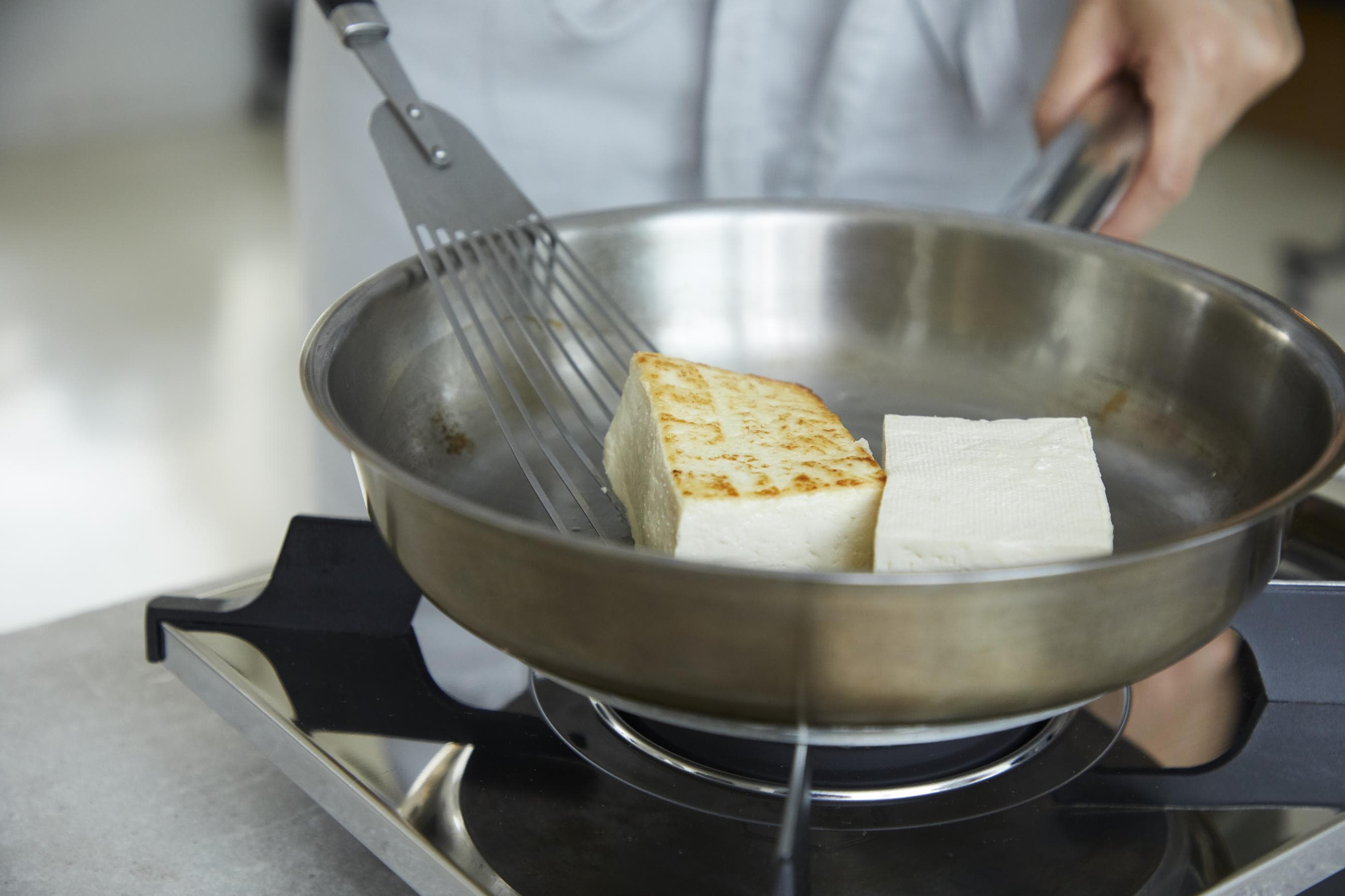 Pan-frying the tofu to golden brown