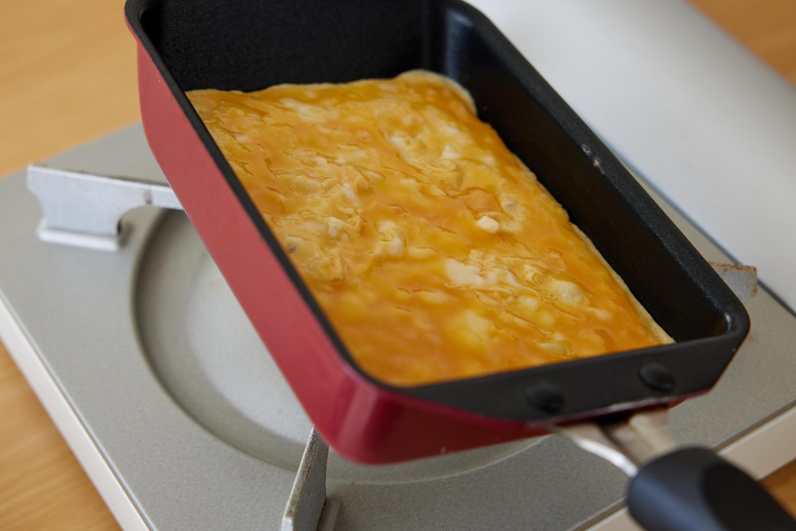 Tamagoyaki pan is tilted to check the Eggs’ Doneness.