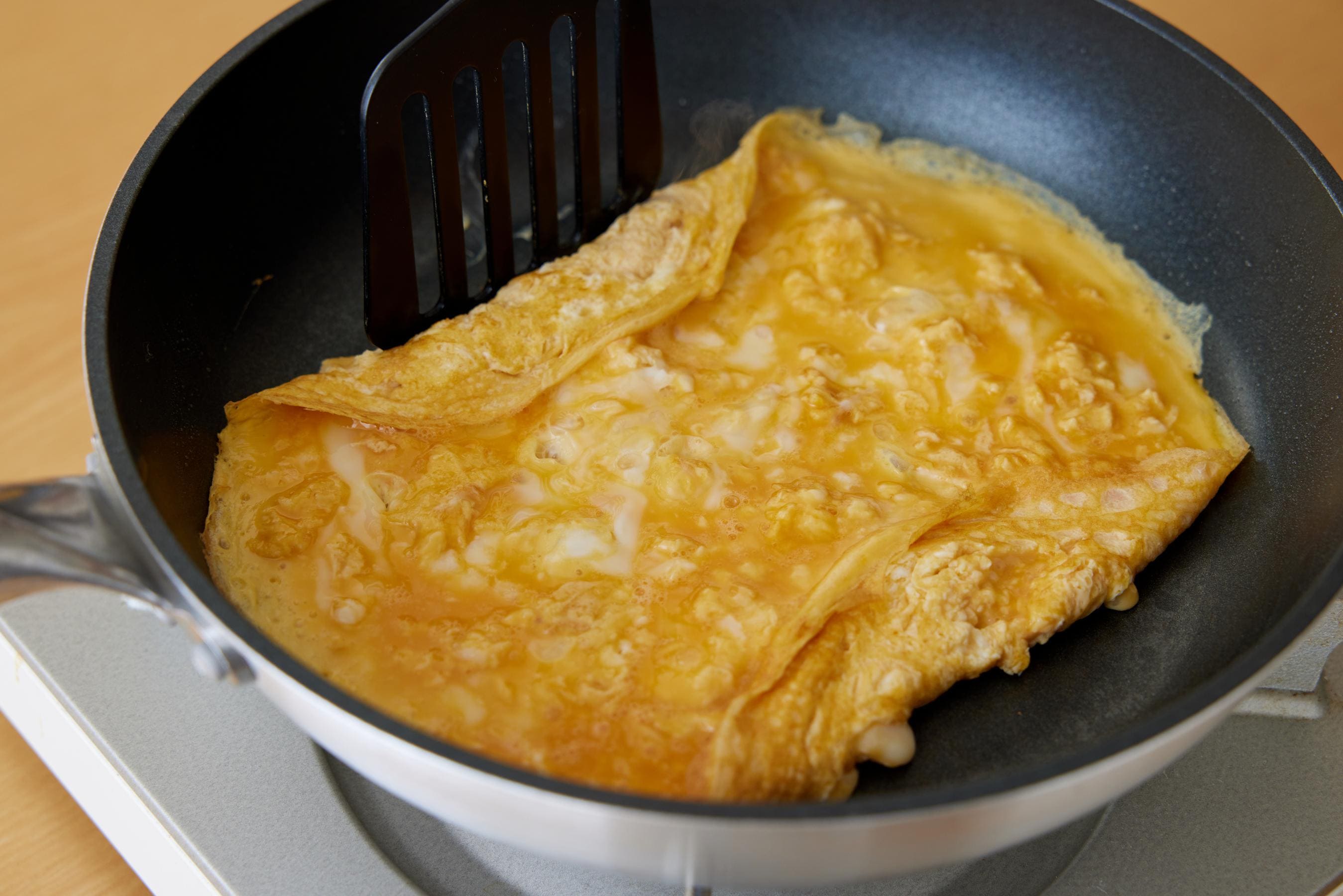 Lift and fold the other side of the fried egg.