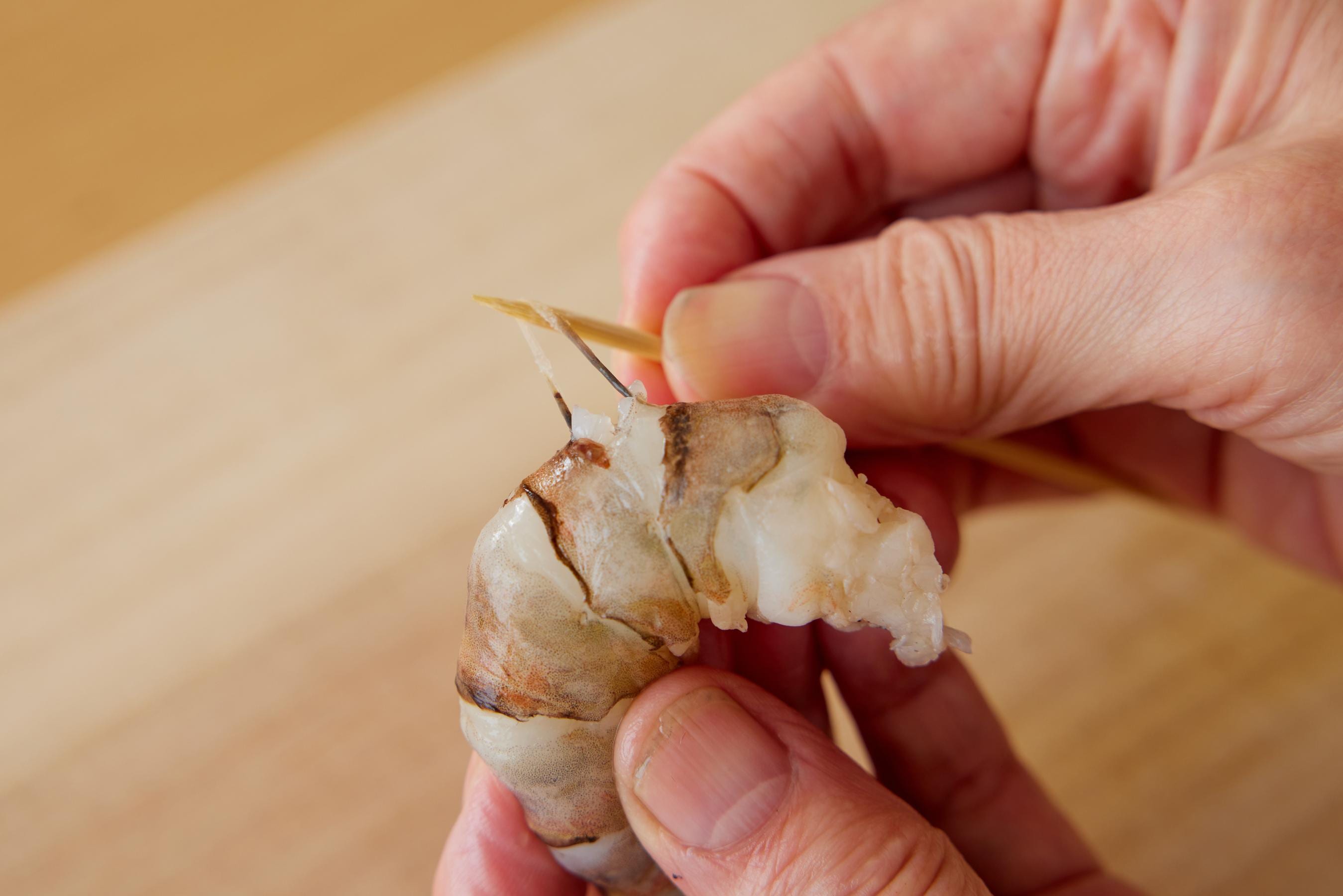 Removing the vein of the shrimp.