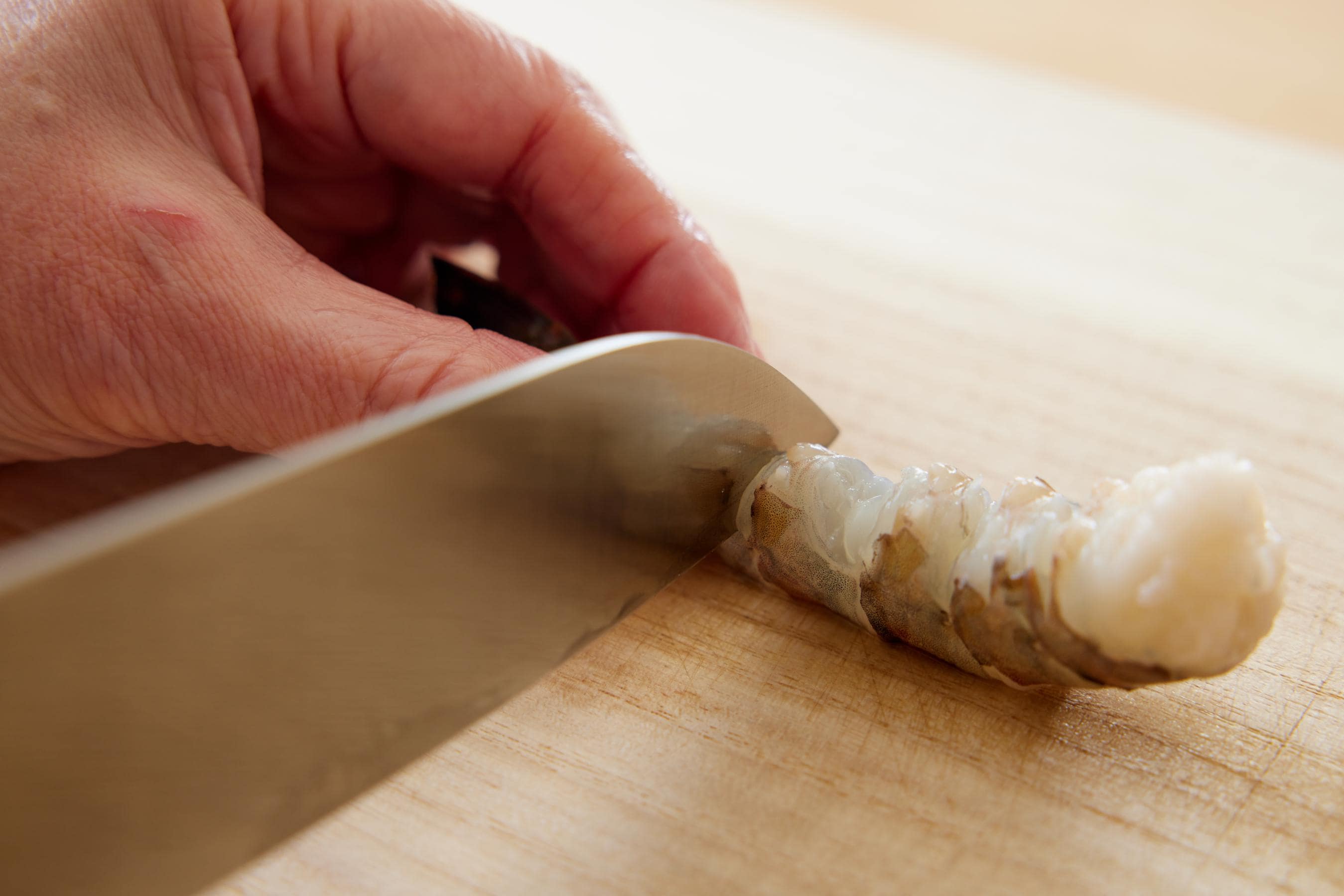 Making incisions along the shrimp.