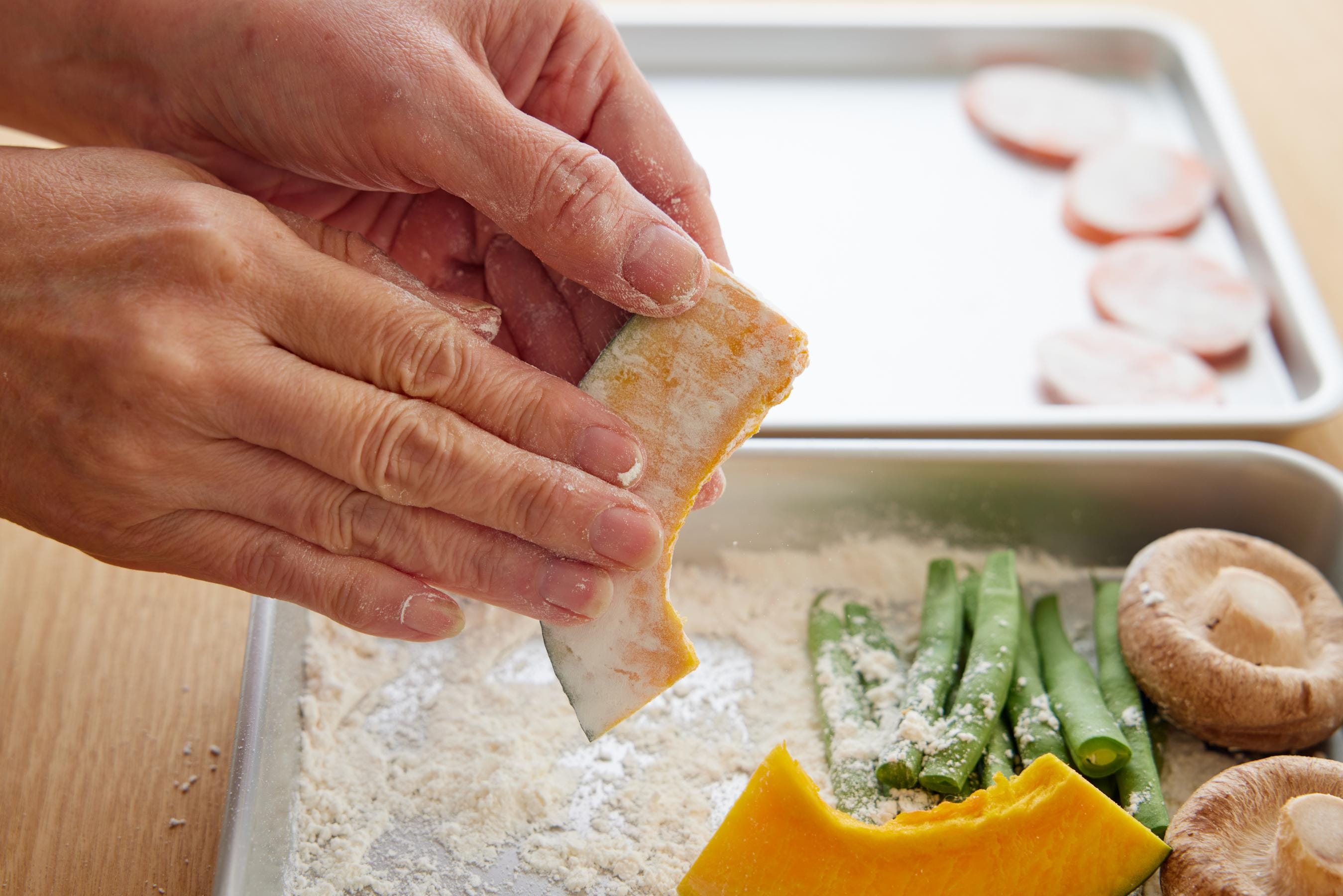 Dusting the vegetables with flour.