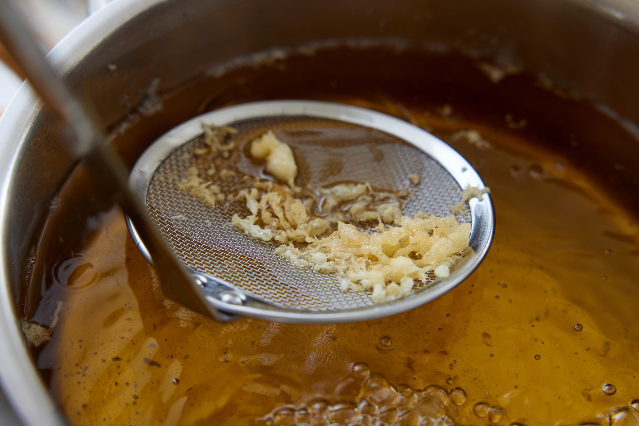 Removing Tempura crumbs.