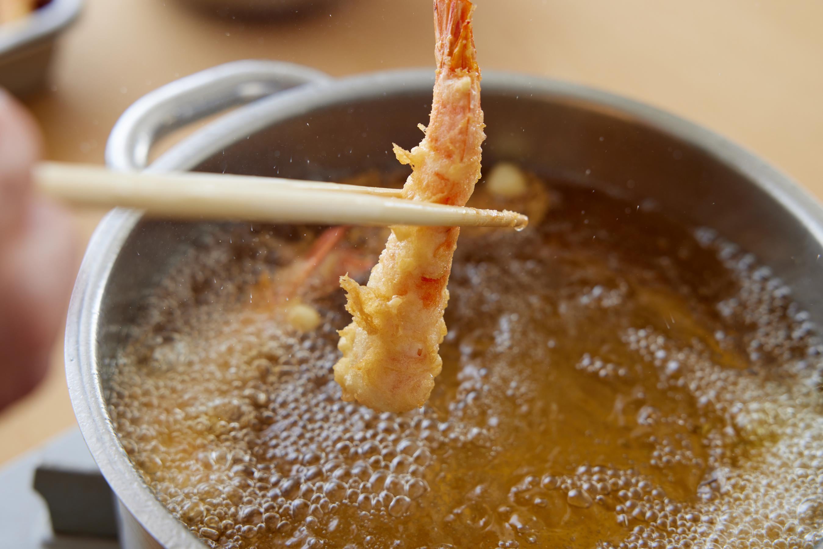 Removing shrimp from the oil.